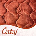 Hrejivá prešívana deka Čataj Picante s potlačou ľudového motívu v tehlovo červenej farbe.