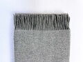 Hrejivá merino deka 140 x 200 cm z 80 % merino vlny a 20 % nylonu. Mäkká, priedušná a príjemná deka so strapcami pre pohodlný oddych doma. Svetlo sivá merino deka.