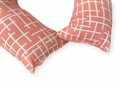Cestovný vankúš s geometrickým vzorom na ružovom podklade pre podporu krčnej chrbtice a hlavy.